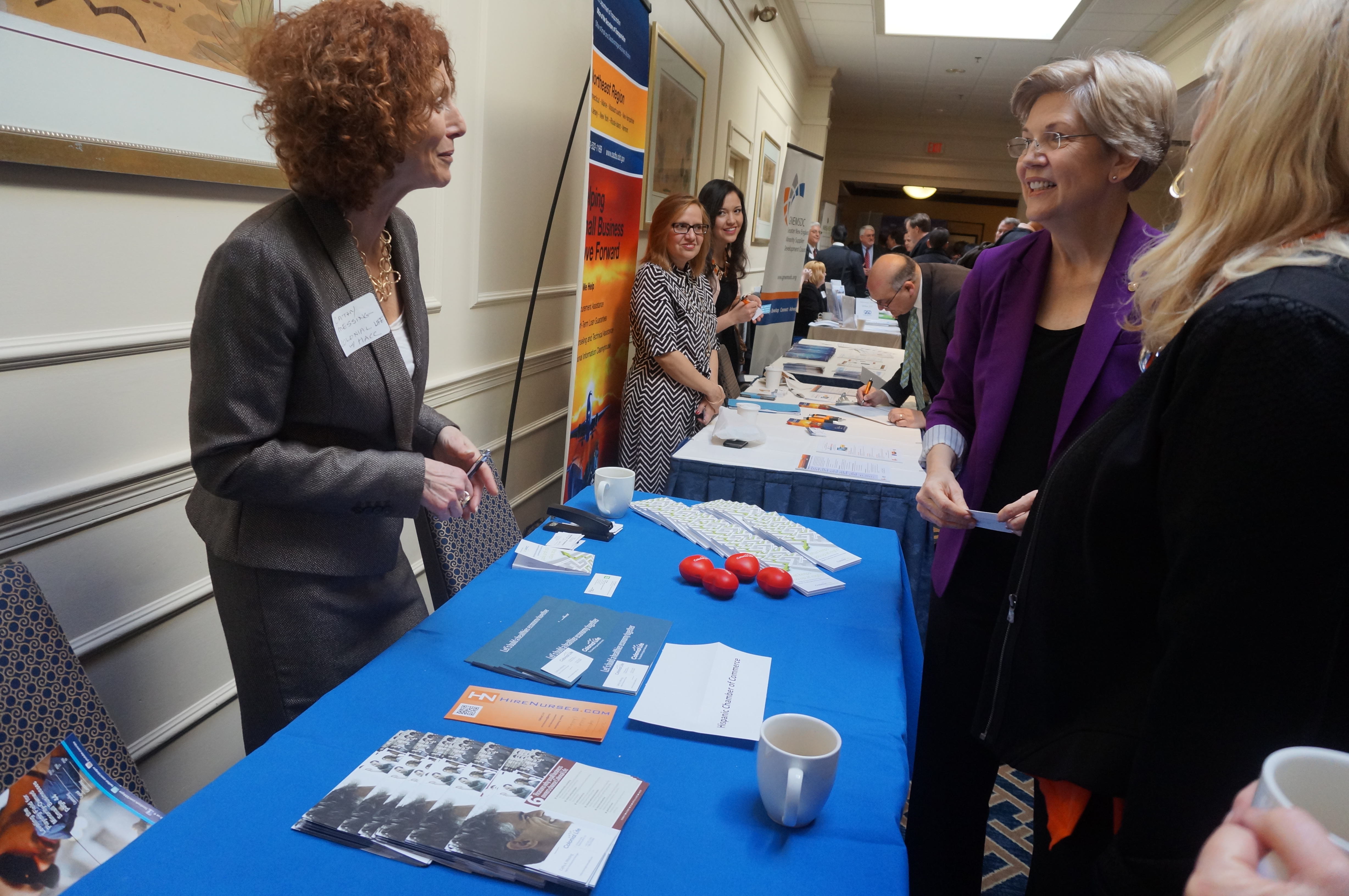 Senator Elizabeth Warren speaks with Cathy Messing of Colonial Life at the Massachusetts Business Matchmaker